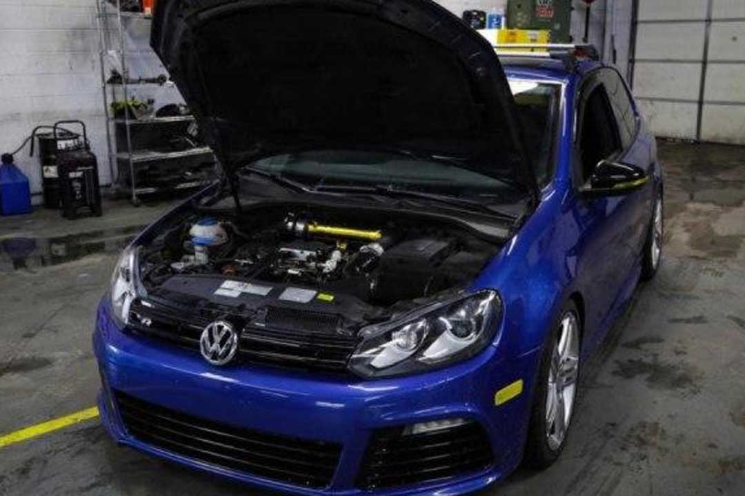 Image of Blue Volkswagen getting an auto oil change.