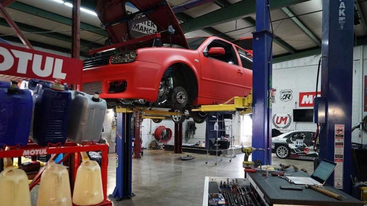 Image of a red Volkswagen getting car transmission repair using diagnostic equipment at Bluewater Performance