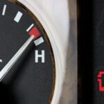 The coolant warning light on your car dashboard indicates that your engine’s coolant level is low.