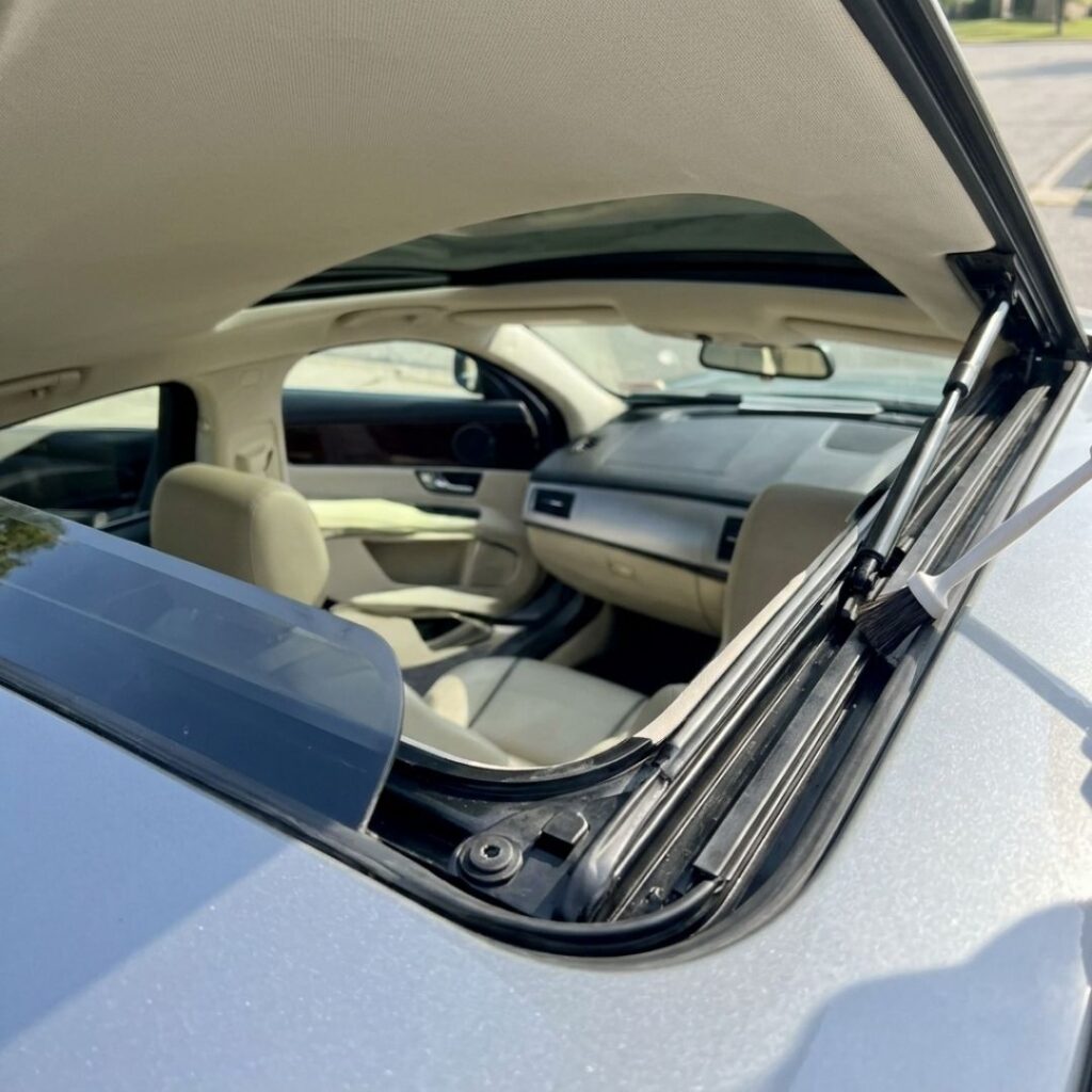 Clear and clean sunroof drain channels on a premium vehicle showing no debris or water build-up.